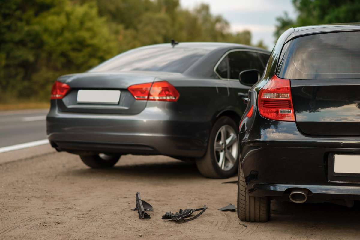 two cars on the side of the road after an accident