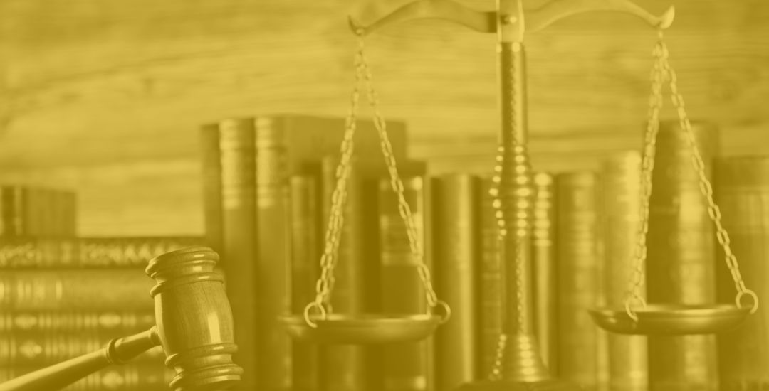 legal books, gavel, and scales of justice on a lawyer's desk