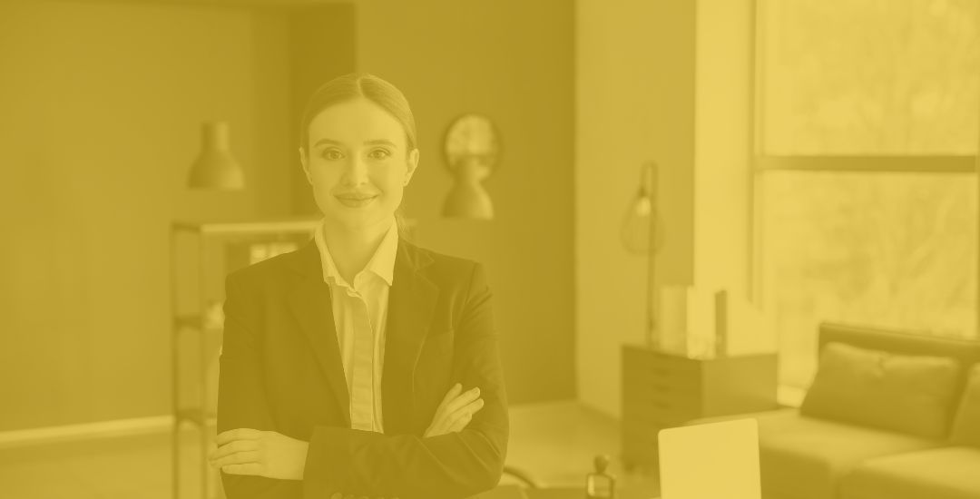 smiling woman lawyer sitting on desk with arms crossed