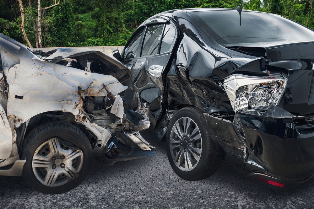 Two vehicles with severe rear and front-end damage after a rear-end collision near Sand Springs