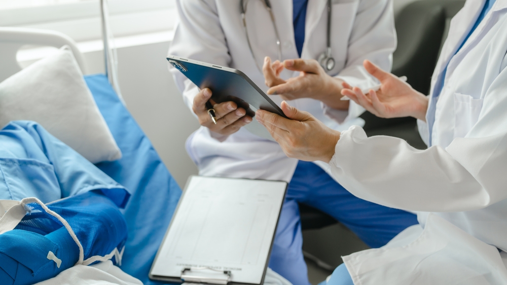 Stylized view of medical team attending to patient with a broken arm in a hospital room