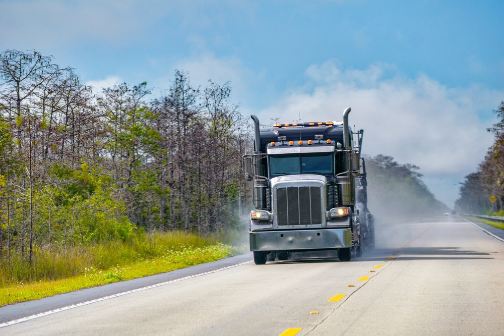 View of the front of a semi truck driving on highway
