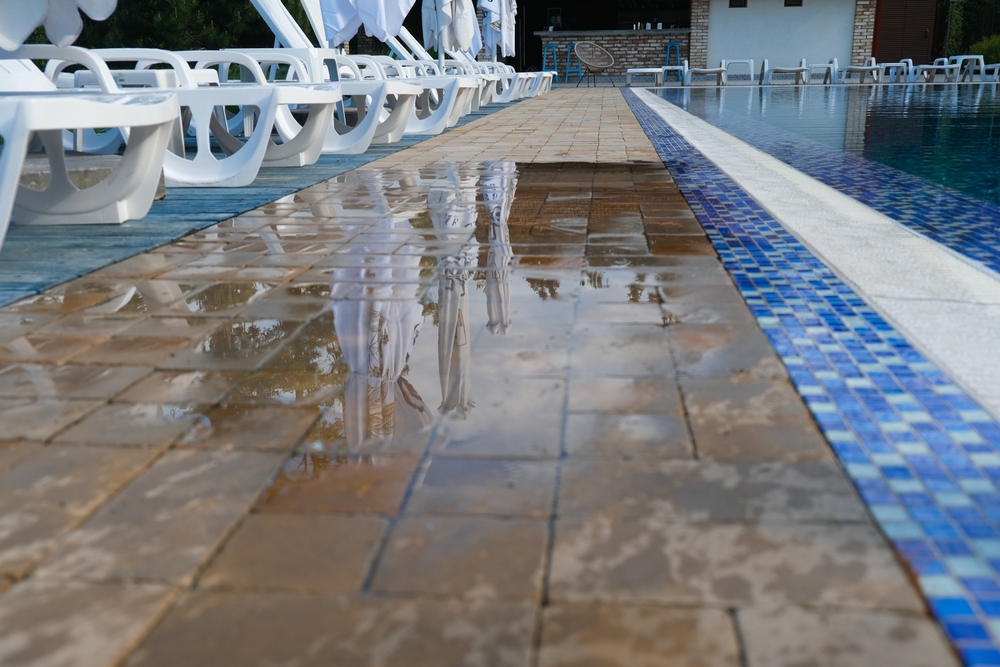 Image of a wet and slippery path next to a swimming pool