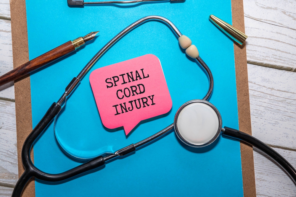 Medical equipment beside a notepad labeled spinal injury