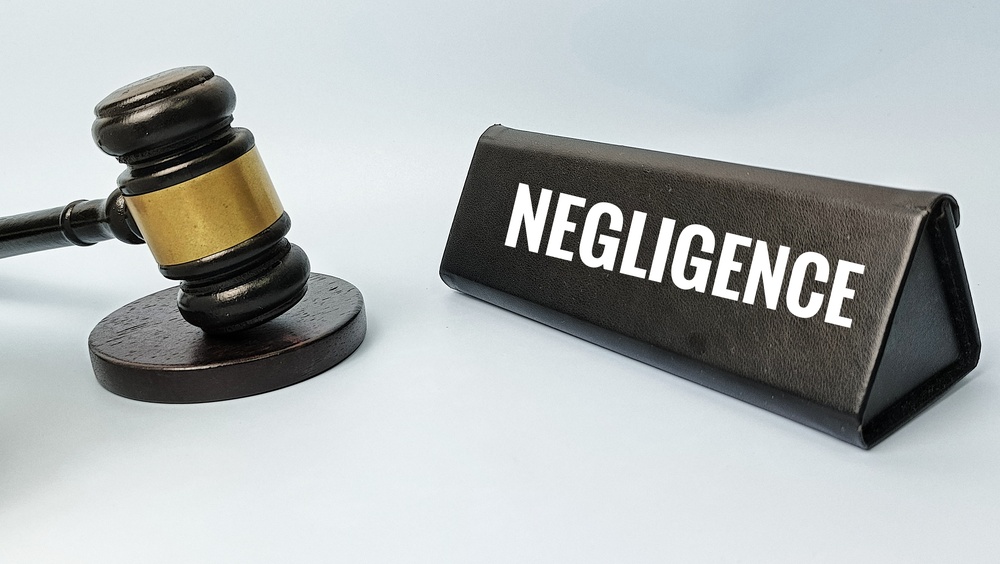 Negligence legal concept with judge gavel representing breach of duty liability damages civil claim lawsuit compensation court justice.
