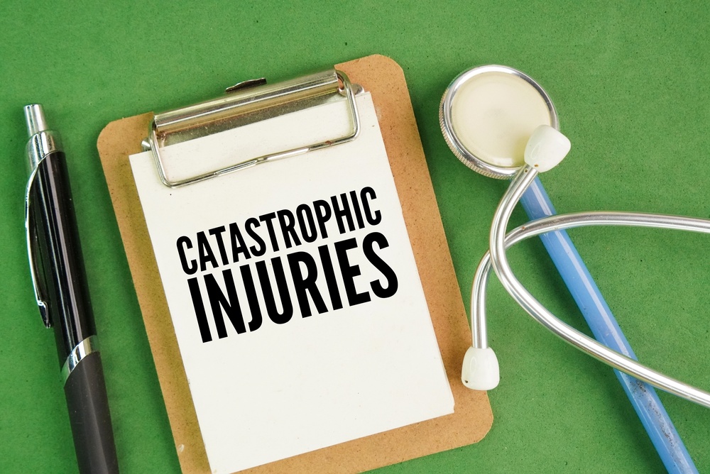 Stethoscope, pen and paper board with word catastrophic injuries. severe, life-altering injuries resulting in permanent disability, significant disfigurement (2)